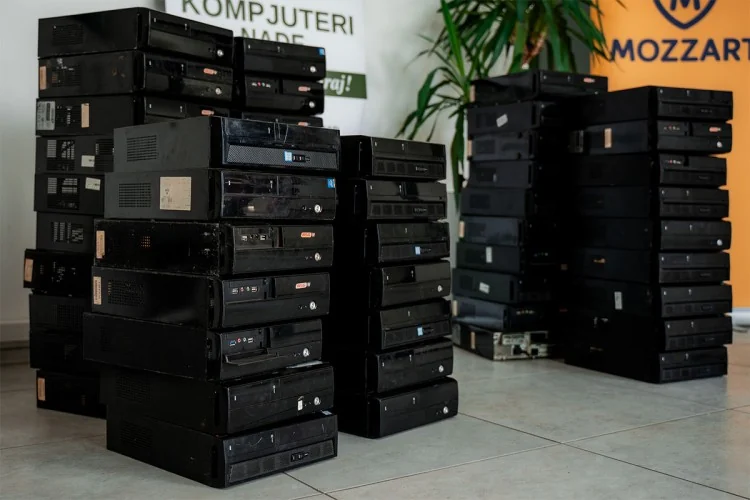 Stacks of desktop computers donated to Kompjuteri Nade