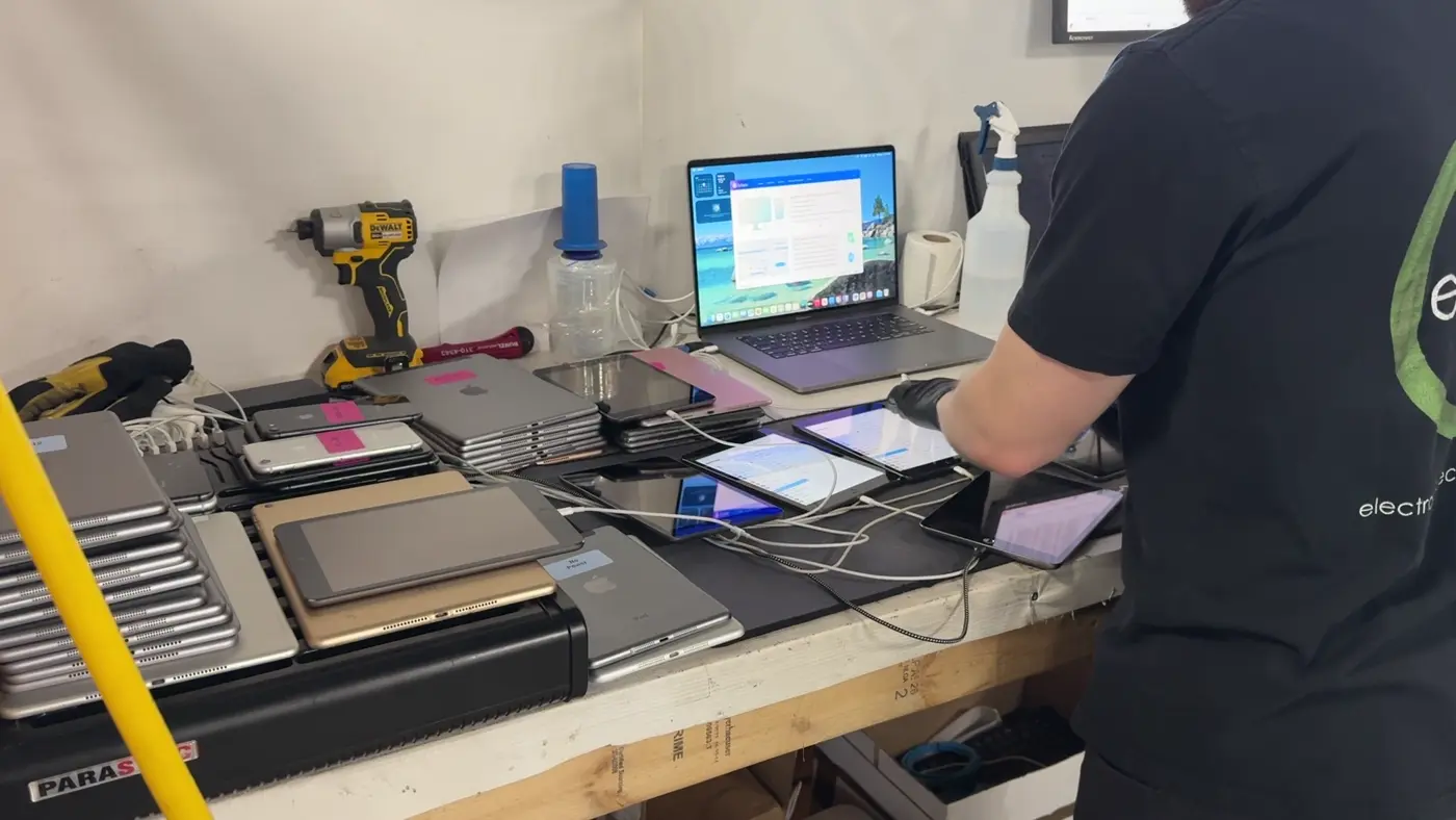 An ERA team member preparing devices at a workbench.