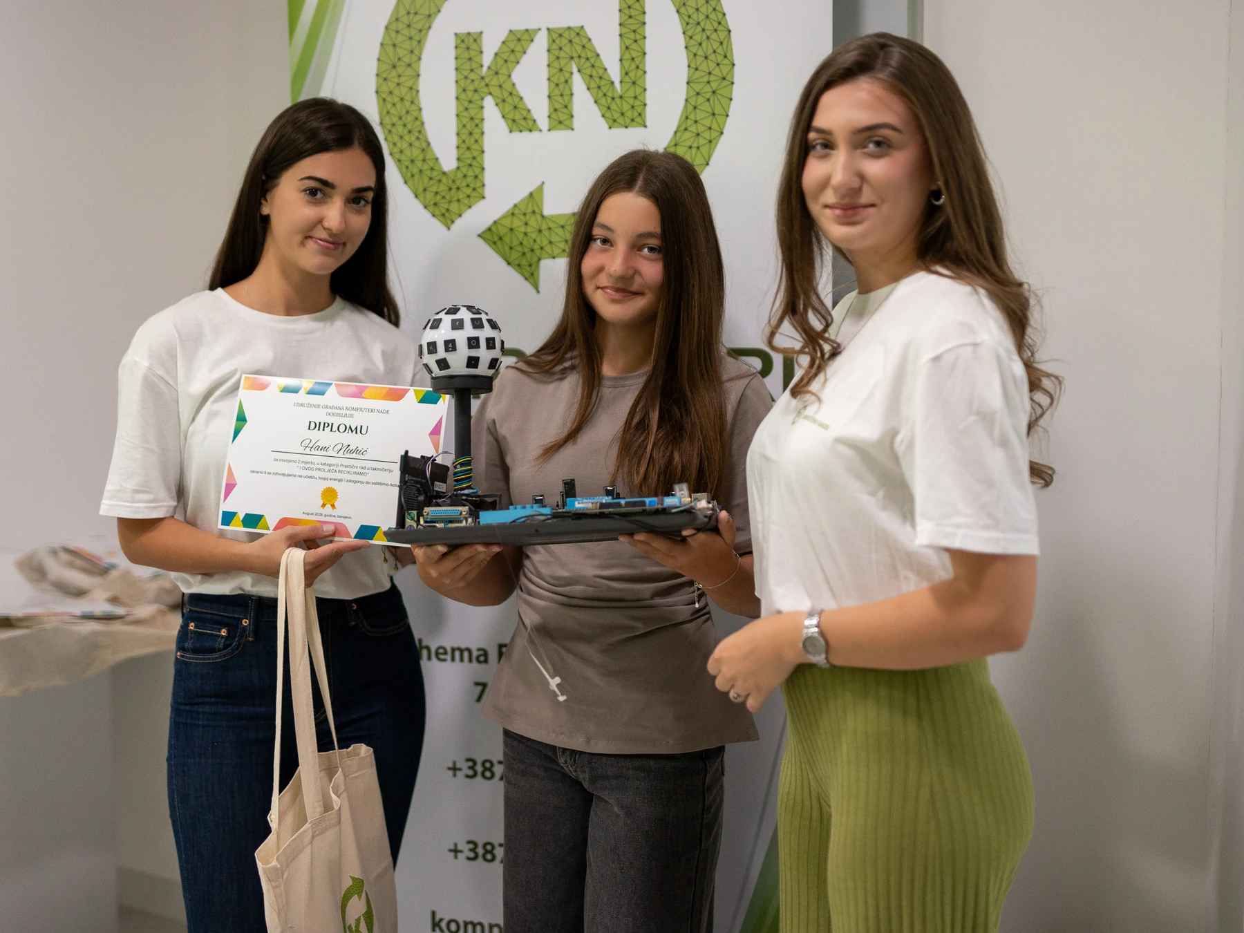 A pupil presenting her recycled-electronics project with KN volunteers at the 2026 competition